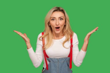 Aman Tanrım, vay canına! Affedilmiş sarışın kadının portresi sürpriz bir şekilde el kaldırıyor, şaşkınlığını dile getiriyor, beklenmedik bir galibiyetle şok oluyor, inanılmaz bir haber. Yeşil arka planda izole edilmiş kapalı stüdyo çekimi