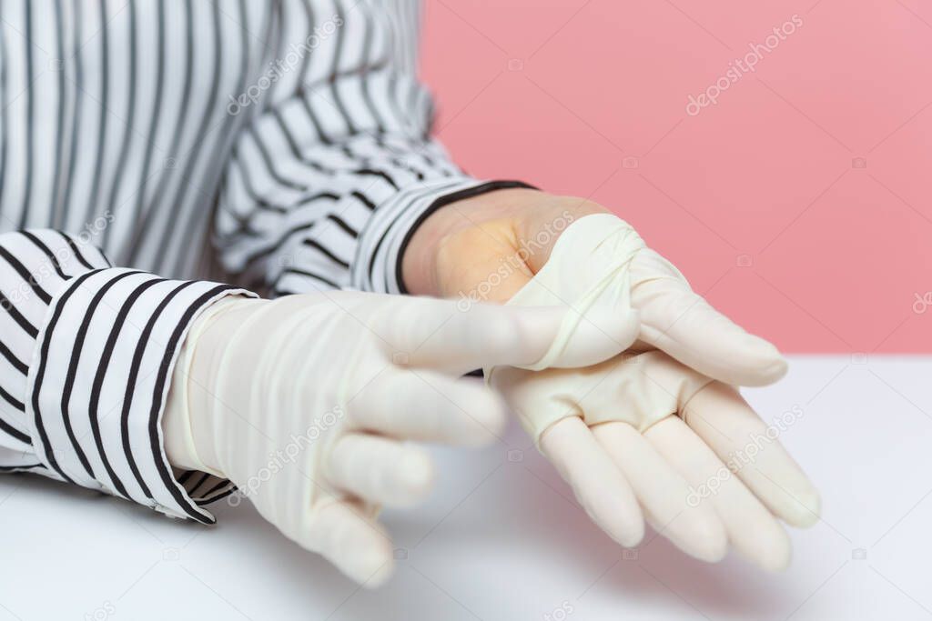 Closeup woman showing disinfected clean hand skin under protective sterile gloves. Hygiene concept, preventive measures during covid-19 epidemic, safety in coronavirus quarantine, healthcare. indoor