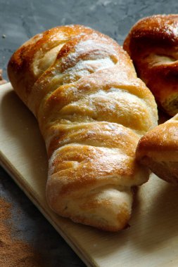 Frash bakery Variety of homemade puff pastry buns cinnamon rolls and croissant on Dark background. Dark still life. Copy space