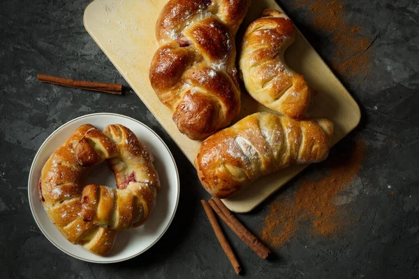 Frash bakery Variety of homemade puff pastry buns cinnamon rolls and croissant on Dark background. Dark still life. Copy space
