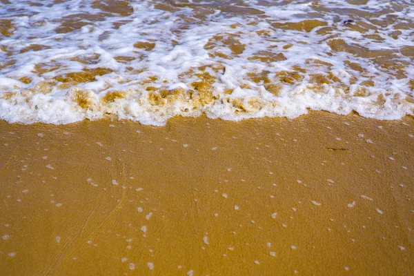Köpüklü deniz suyuyla altın rengi kum — Stok fotoğraf