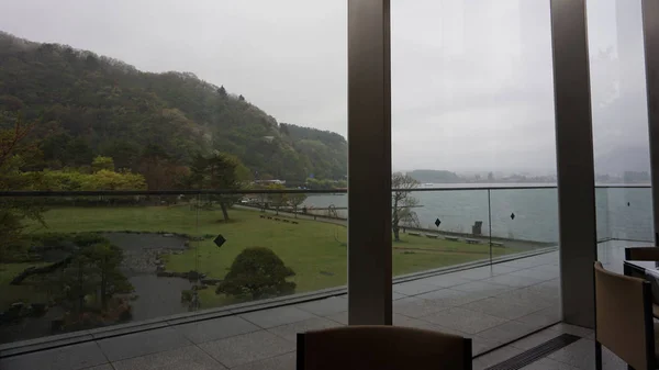 Cloudy rainy day outside the window. Along the road at Kawaguchi lake, Japan