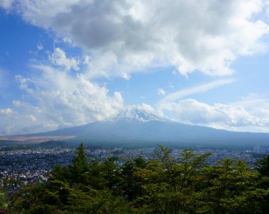Fuji Dağı ve bulutlu mavi gökyüzü. Fujiyoshida şehri Fuji Dağı 'nın kuzey üssünde yer almaktadır.