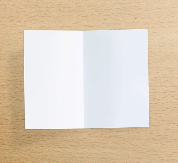 Livro branco sobre a mesa de madeira de fundo — Fotografia de Stock