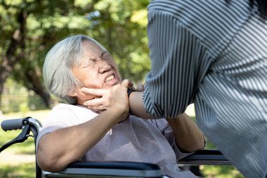 Asian senior mother were physically abused,angry daughter or female caregiver use hands to strangle old people neck and fight, hit, attack,physical abuse elderly alzheimer patient,family stop violence