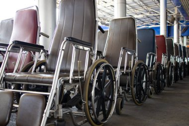 Wheelchair for elderly patients and disabled people with good quality and standards,Many of wheelchairs lined up and ready for use,services of hospital to help,care and facilitated medical treatment 