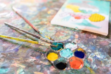 Closeup,artistic tools on colourful table,drawing and palette, paintbrush to painting watercolor on canvas,learning,activity and development of children,creative ideas,education, art concept
