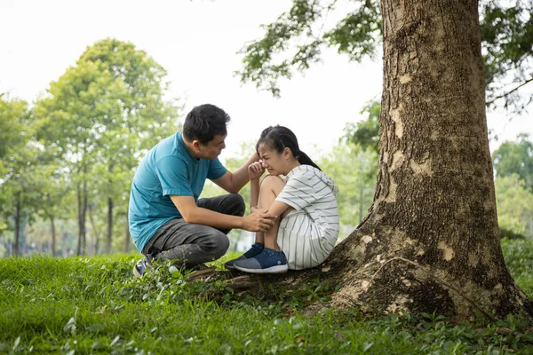 Stressed asian child girl sitting crying and thinking about problems at park,sad female teenage having psychological trouble with depressive symptoms feel despair,depression, sorrow,mental disorder — Stockfoto