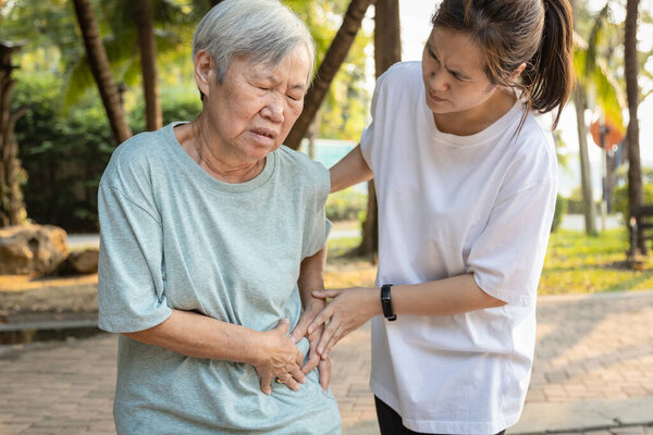 Sick asian senior woman with belly pain,elderly have severe stomach ache,left side,patient with acute pancreatitis hold hand left stomachache,abdominal pain,inflammatory bowel disease,irritable bowe