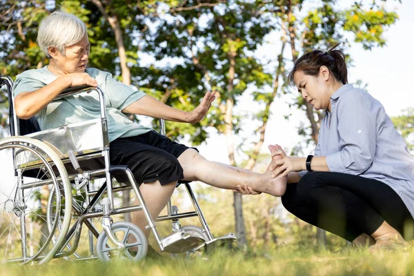 Asian senior woman suffering from leg cramp,female elderly stretching painful calf muscle,adult caregiver helping care the old people who have leg cramps injury,receiving a leg massage,health problem — Stock Image Asian Senior Woman Suffering Leg Cramp Female Elderly Stretching Painful Royalty Free Stock Images