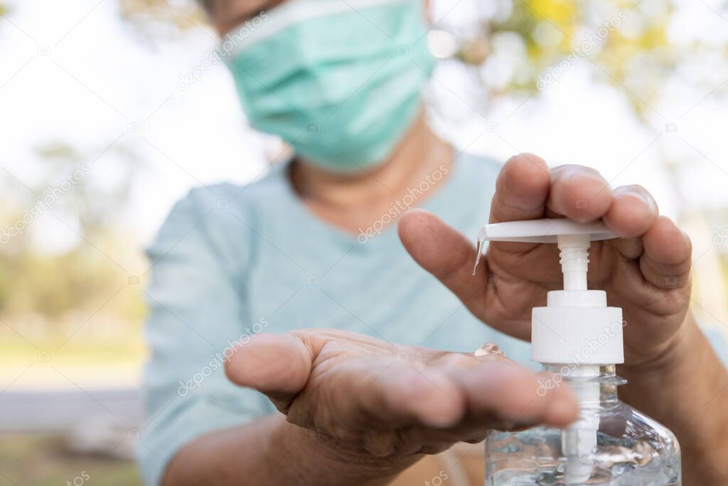 Asian elderly people wearing protective mask,using alcohol antiseptic gel,prevent infection,outbreak of Covid-19,senior woman washing hand with hand sanitizer to avoid contaminating with Coronavirus  