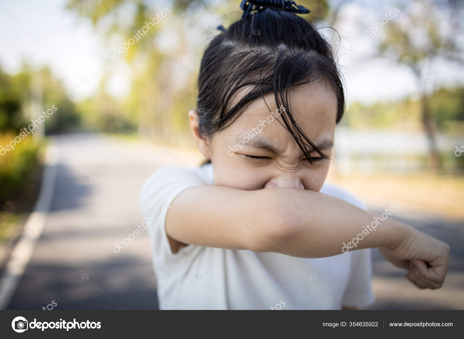 Child Coughing Into Elbow