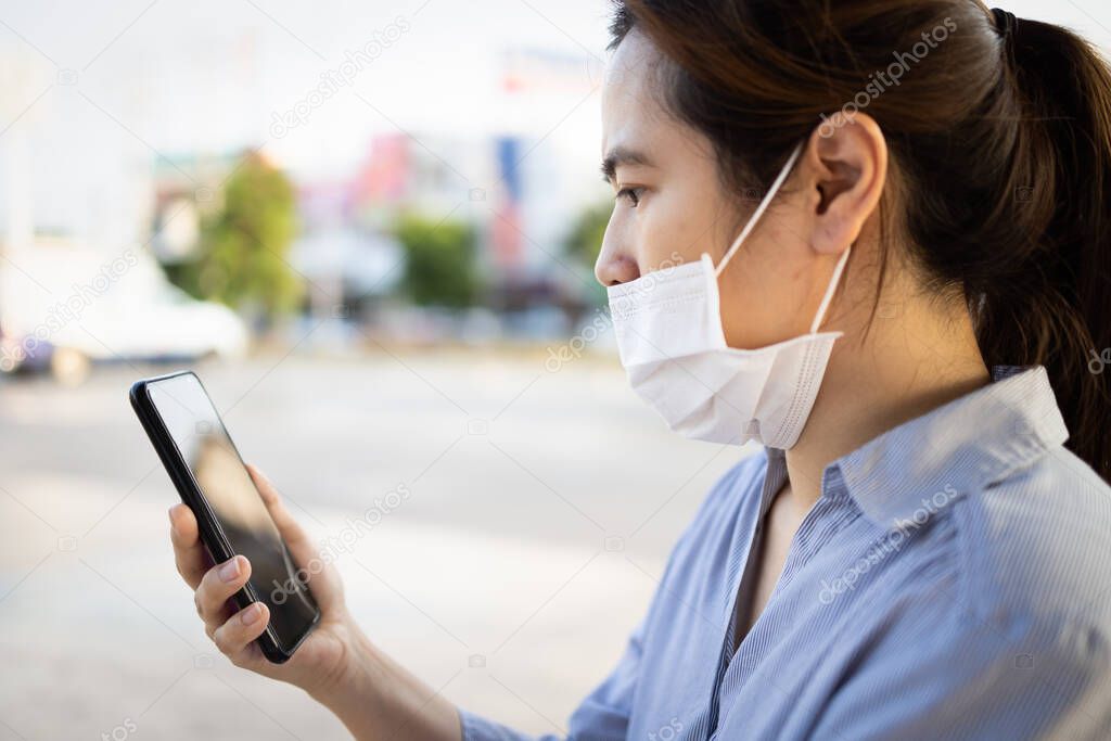 Asian woman with medical protective mask,not covering her nose,female people wear face mask that is wrong,does not block the nose,risk of contagious disease,infection of Coronavirus,spread Covid-19 