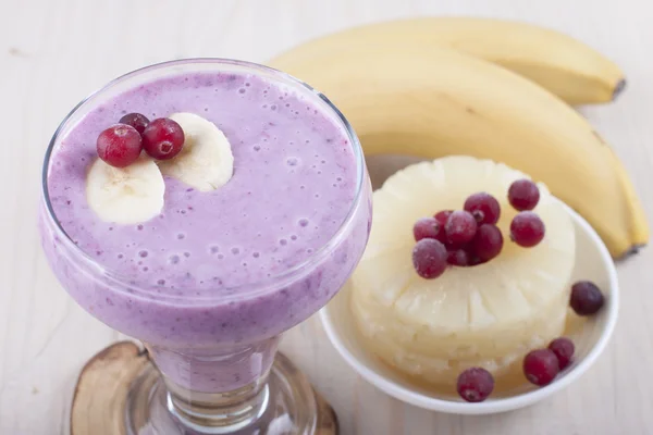 Smoothies of banana, canned pineapple and frozen cranberry  .