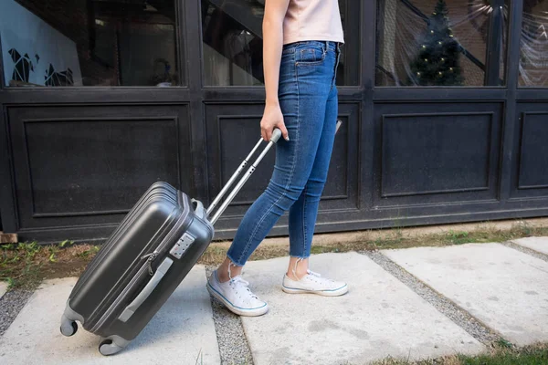 Woman with travel trolley luggage in hotel lobby.Travel concept.