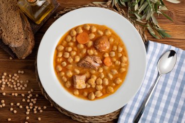 Nohut güveci (potage - cocido Madrid). Biftek, sosis (sucuk), pastırma, havuç ve zeytinyağıyla. Kırsal görünüm. Üst görünüm.