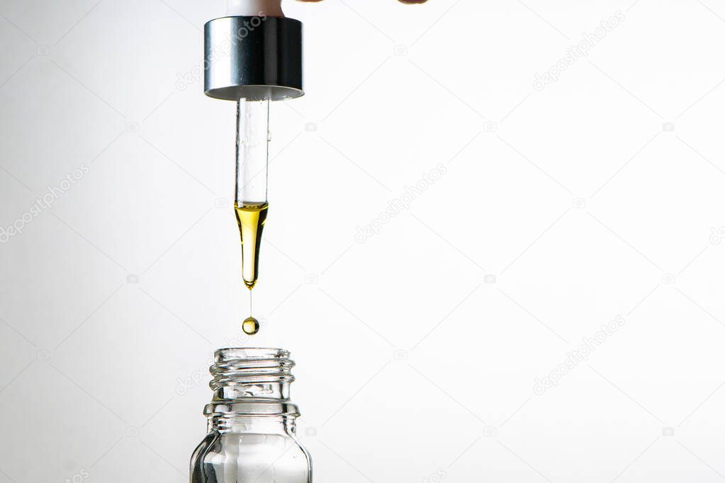 Glass bottle with dropper. Studio. Medical cannabis, essential oils or anti aging serum concept