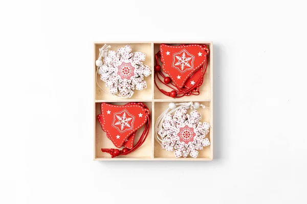 Новорічна прикраса дерев'яної коробки з червоними та білими предметами. Вид зверху . — стокове фото