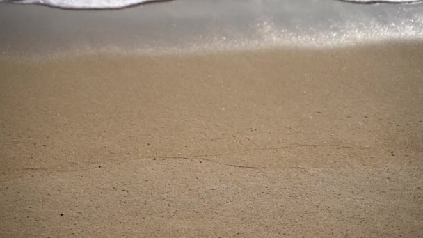 Close-up slow motion beelden van zee golven wassen van het zandstrand — Stockvideo