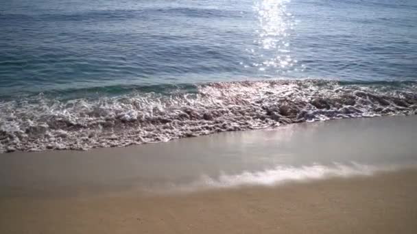 Szoros lassított felvétel tengerhullámok mossa le a homokos tengerparton — Stock videók