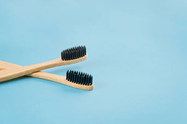 Two bamboo toothbrushes on bluw background. Eco friendly lifestyle — Stock Photo, Image