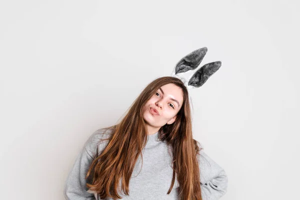 Teenager girl posing with bunny grey ears on white ackground. Easter spring season — ストック写真