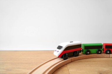 Wooden railway and train at home on the floor. Creative play toys