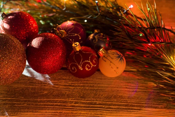 Ahşap bir arka planda yuvarlak yeni yıl çelenk. Yılbaşı süsleri, topları, çelenk, Ladin, ampuller
