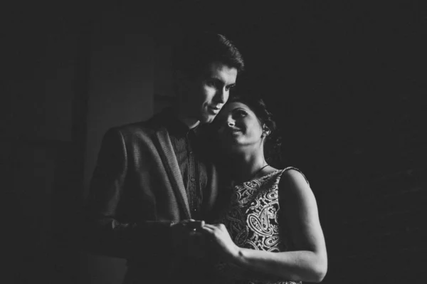 romantic couple on a black background, hugs