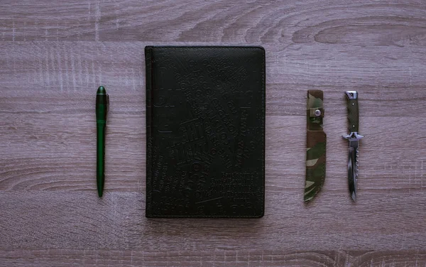 Tükenmez kalem defter, ahşap arka plan, üstten görünüm üzerinde bıçak ile.