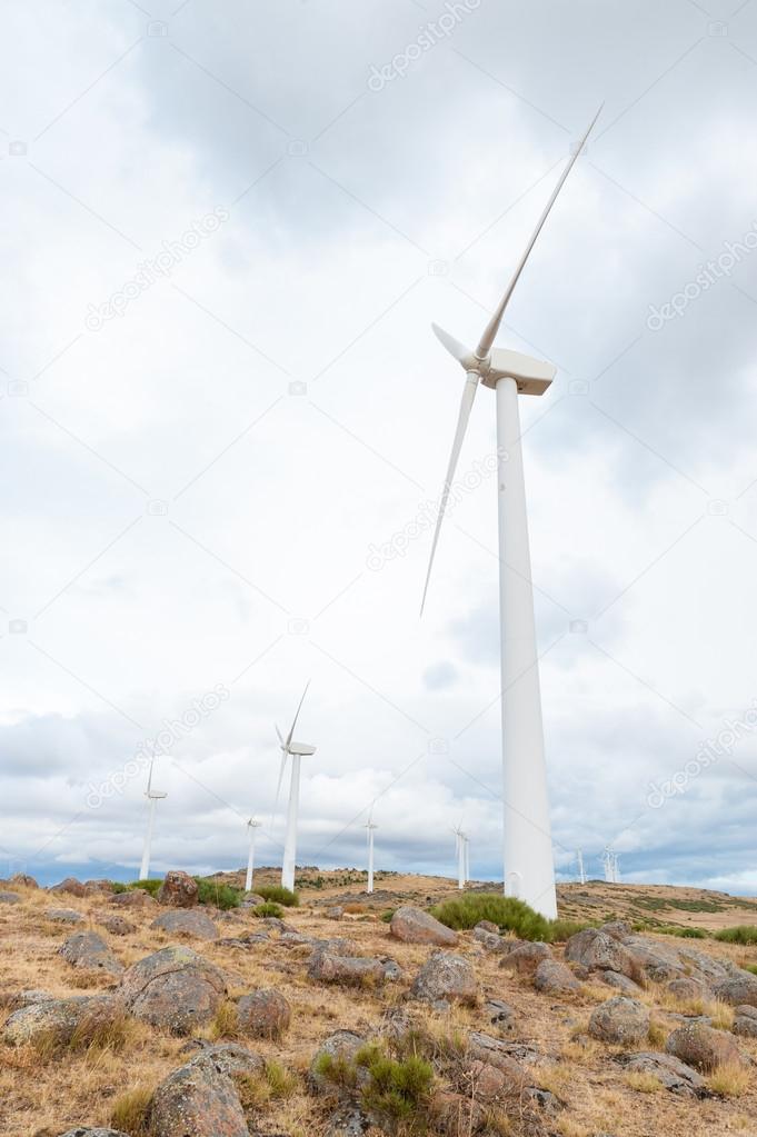 wind turbines on the mountain on cloud isolated on blue sky