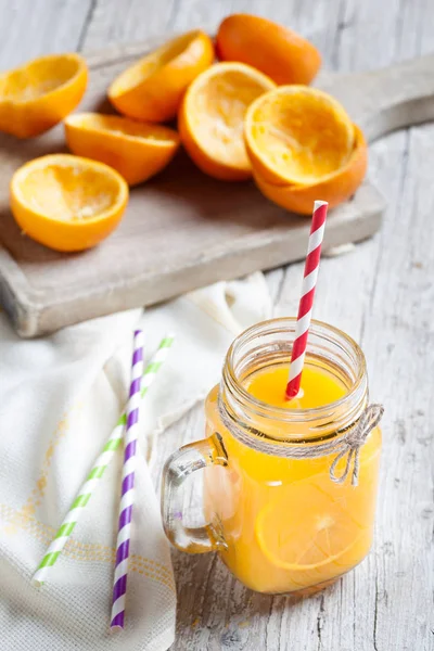 Orange juice on glass on wooden table rustic — Stock Photo, Image