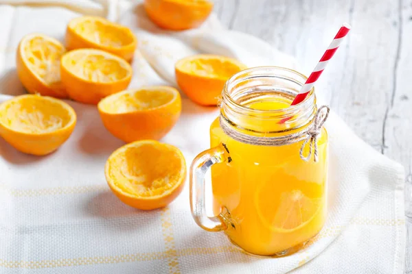 Tasty oranges squeezed with glass in the foregroun — Stock Photo, Image