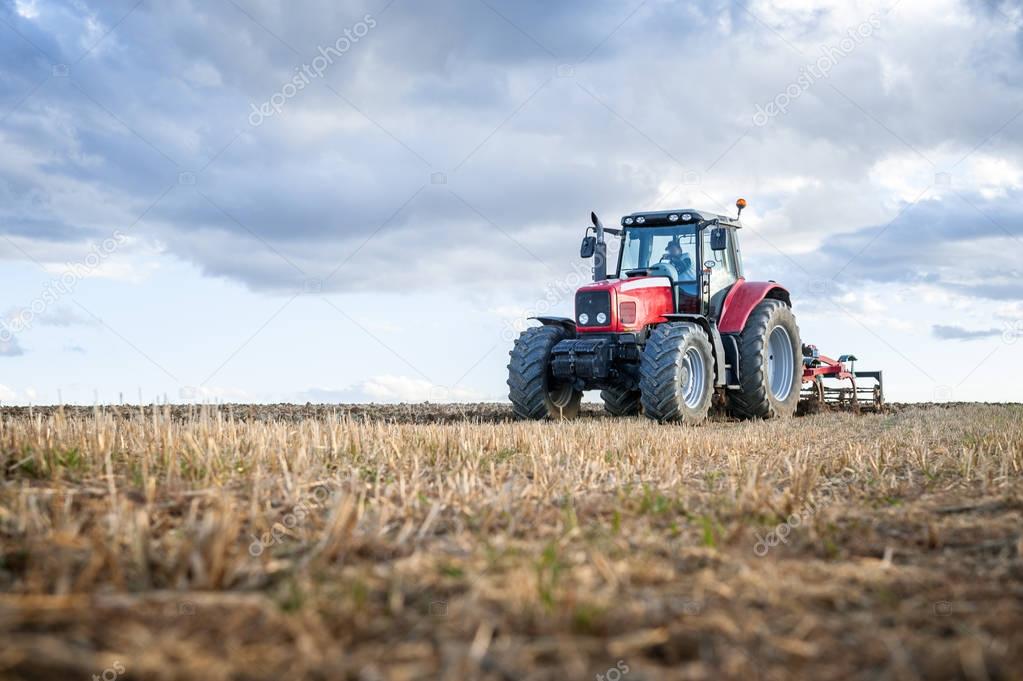 agricultural tractor in the foreground with blue sky background