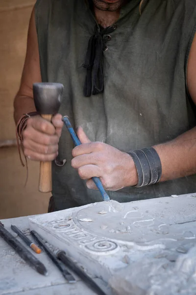 Mains de l'homme travaillant avec le marteau et le ciseau dans l'artisanat worksho — Photo