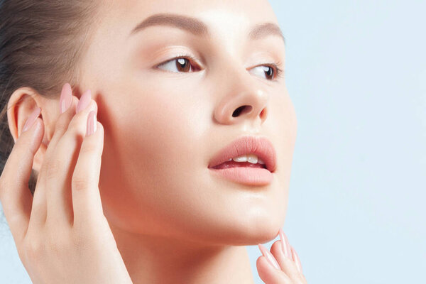 Young beautiful woman with clean perfect skin close-up. Beauty portrait