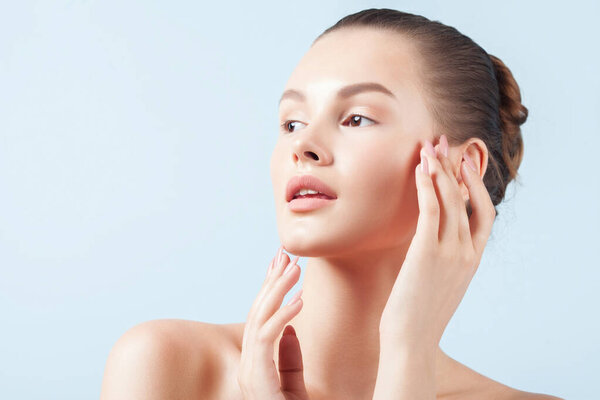 Young beautiful woman with clean perfect skin close-up. Beauty portrait