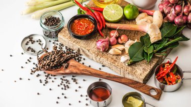 Spices for use as cooking ingredients on a wooden background with Fresh vegetables. Healthy food herbs. Organic vegetables on the table