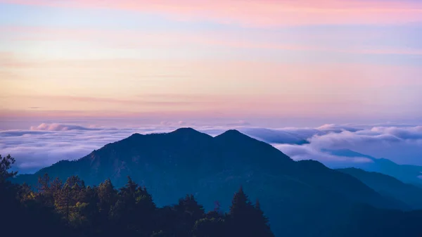 Mountain fog valley during sunrise.The background of nature with fog on the mountain, In the rainy weather in the countryside