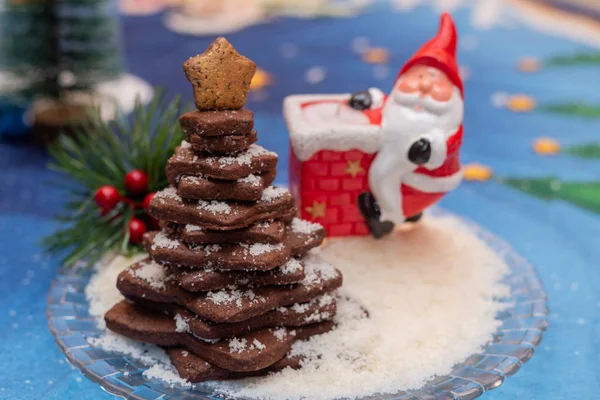 Stacked cocoa cookies christmas tree with colourful christmas background