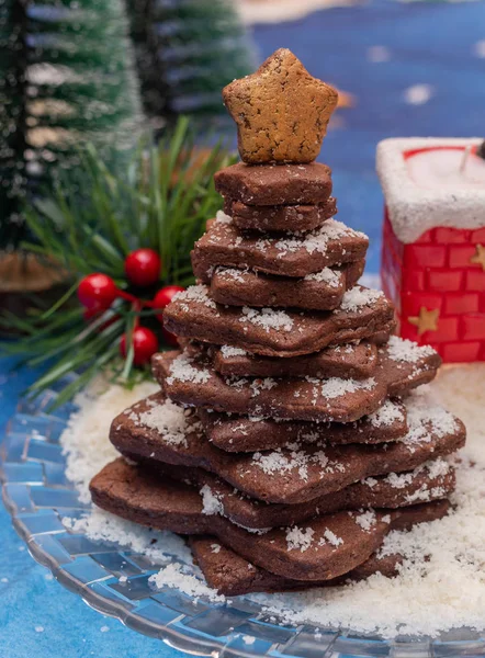 Stacked cocoa cookies christmas tree with colourful christmas background