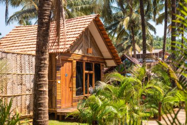 Beach huts and cottages made from bamboo,clay tiles and coconut leaves. Holiday destination concept images in Goa, India. Scenic Vacation and nature images for travel clipart