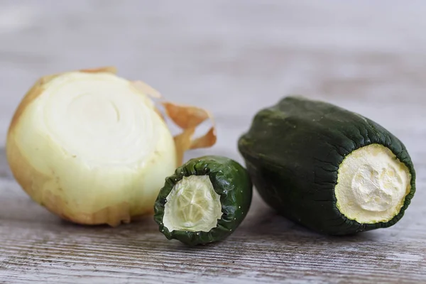 Expired vegetables over a wooden table