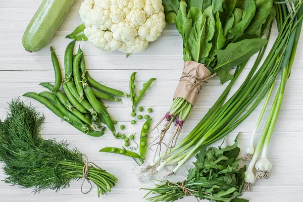 Composition on a dark background of green organic vegetarian products — Stock Photo, Image