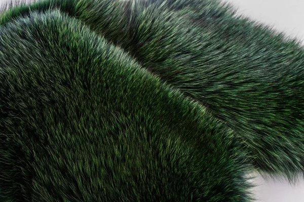 Luxury and elegant fluffy clothes. Dyed furry coat in green color, close up. — Stock Photo, Image