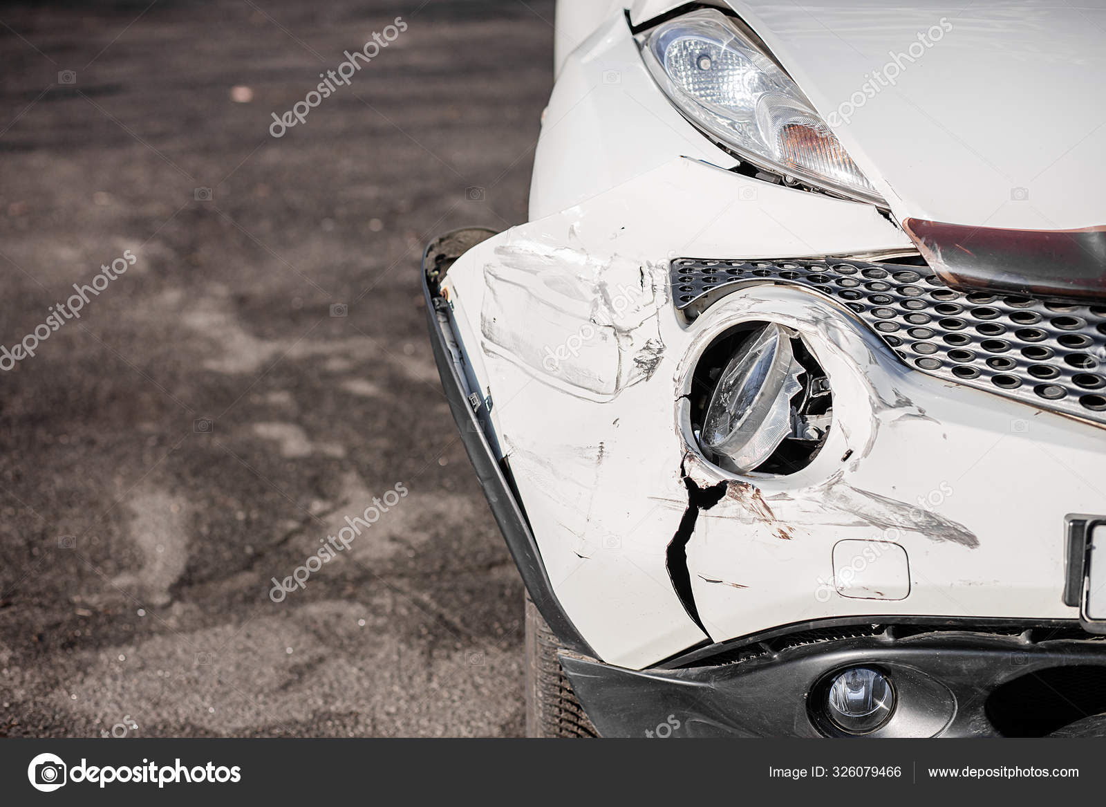 Broken Car after a Crash. Damaged Wing and Headlamp of a Car