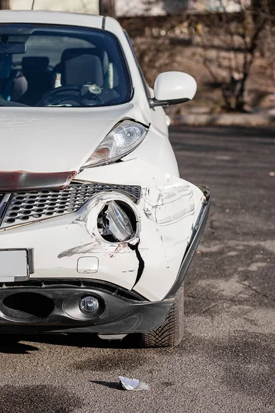 Car accident or accident. The front wing and the right headlight are broken, damage and scratches on the bumper. Broken car parts or close-up.