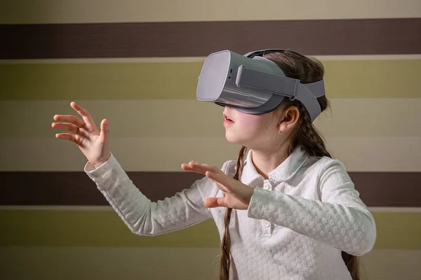Meisje met een virtual reality headset. Het meisje verkent de wereld van de virtuele realiteit door middel van video en games. — Stockfoto