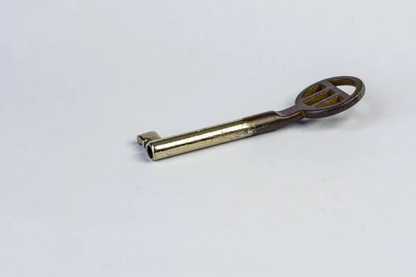 Alter gebogener Schlüssel zu einer Schatztruhe auf weißem Hintergrund — Stockfoto