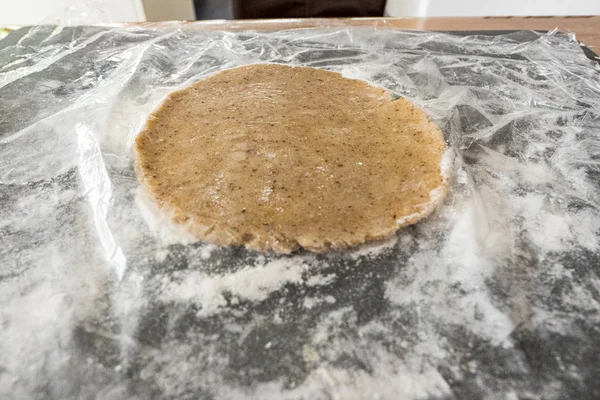 Round raw dough for christmas cookies on foil — Stock Photo, Image